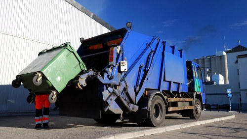 Company vehicle and skip at site facing customer view