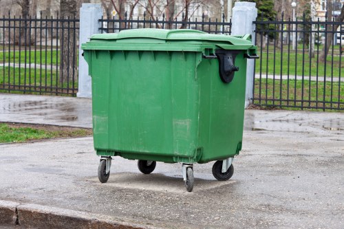 Construction workers managing waste in a skip