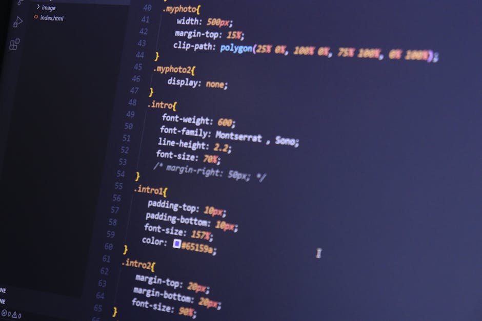 The image displays a close-up of a computer screen showing lines of coding in a text editor, with syntax highlighting in various colors such as orange, blue, and white. The code appears to define styl